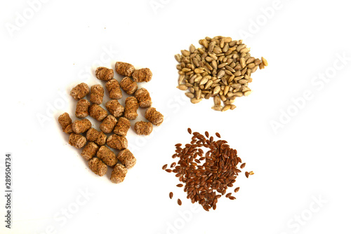 Cereals and seeds: sunflower, flax and bran closeup on a white background