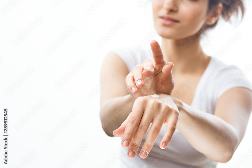 woman applying cream on her face woman applying cream on her face
