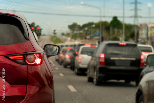 ฺBrake of red car on asphalt roads during rush hours for travel or business work. stop by traffic light control.