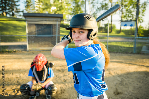 Photography Girl baseball player with bat on the playground