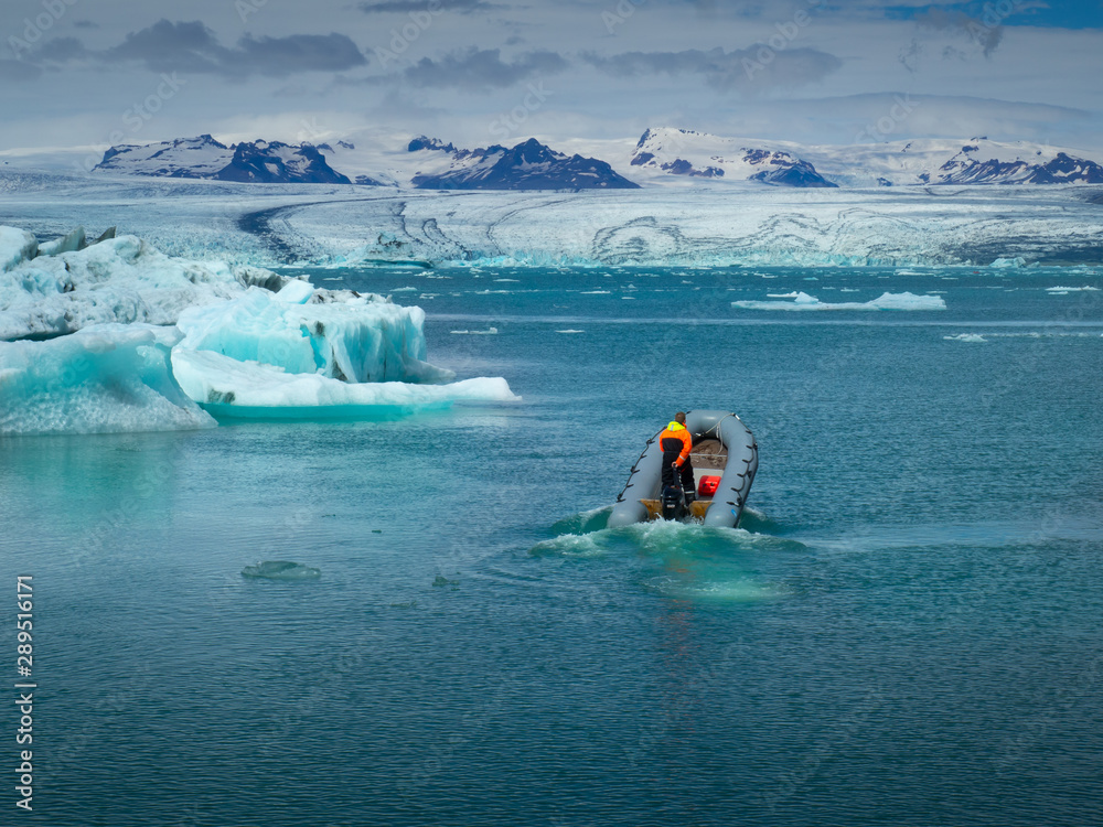 The man is sailing on a speedboat on Jökulsárlón lagoone