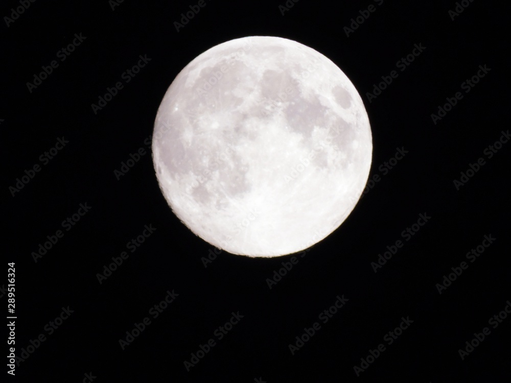 Genova, Italy - 09/12/2019: An amazing photography of the full moon over the city of Genova by night with a great clear sky in background and some stars Genova, Italy - 09/12/2019: An amazing photography of the full moon over the city of Genova by night with a great clear sky in background and some stars