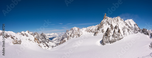 Panorama of the snow covered glacier on top of the Mont Blanc Massif between Italy and France, the highest mountain in Europe with wind blowing snow from the highest peak © Niccolo