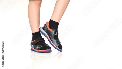 close up photo boy's legs in black sandals with socks
