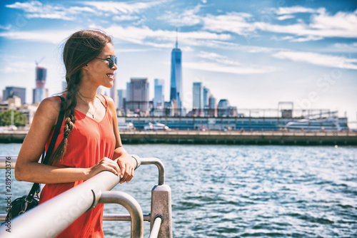 New York city woman tourist walking in summer vacation USA travel lifestyle. Tourism in the USA NYC skyline with One World Trade center in background.