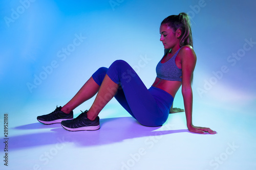 Full shot of woman with blue background