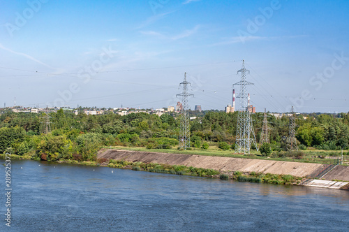 High voltage steel poles on the river bank