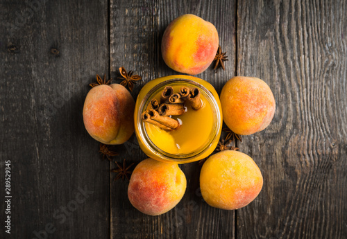 Fototapeta Naklejka Na Ścianę i Meble -  Fresh peach juice with cinnamon spices in jar. Selective focus. Shallow depth of field.