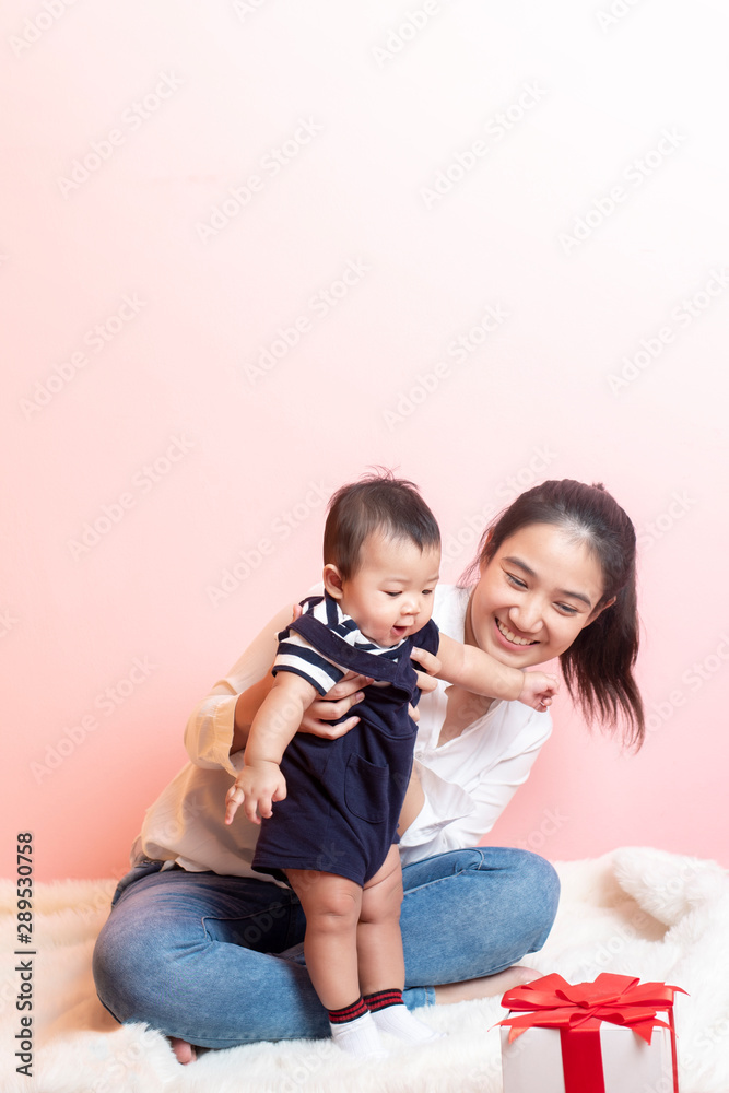 Happy newborn cute baby and beautiful mom in studio Happy newborn cute baby and beautiful mom in studio