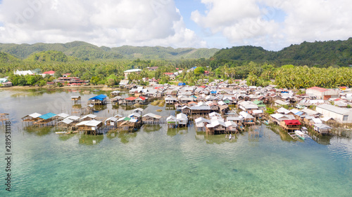 Dapa, Siargao, Philippines. Fishing village with wooden houses, standing on stilts in the sea, top view. Landscape in the Philippines.