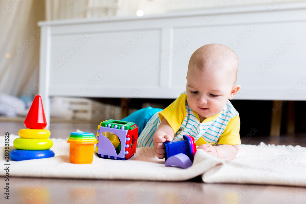 Early development of the child with educational toys. The kid is playing plastic toys. Children education. Early development of the child with educational toys. The kid is playing plastic toys. Children education.