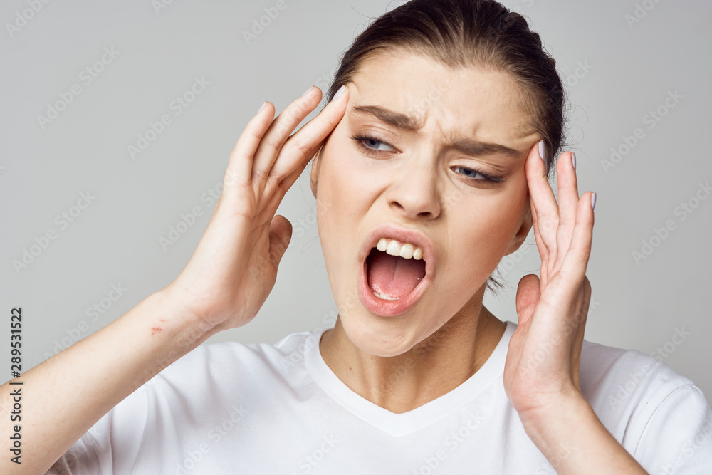 young woman with headache isolated on white young woman with headache isolated on white