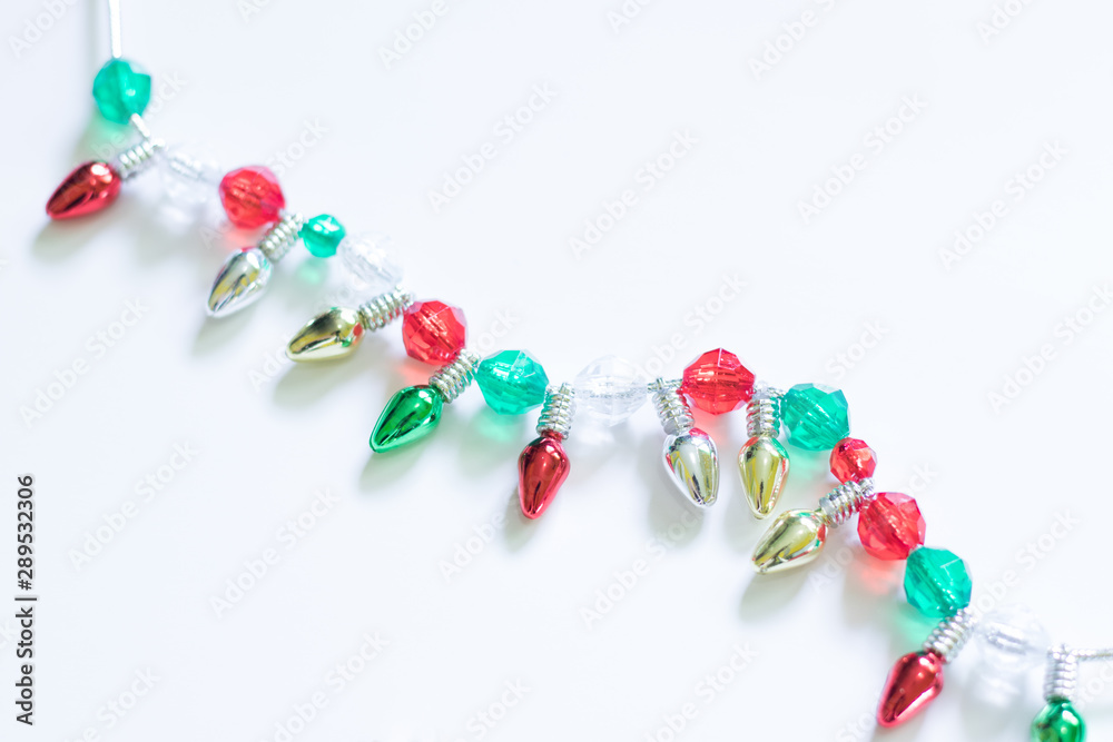 Christmas Tree Lights and Beads on a White Background Christmas Tree Lights and Beads on a White Background