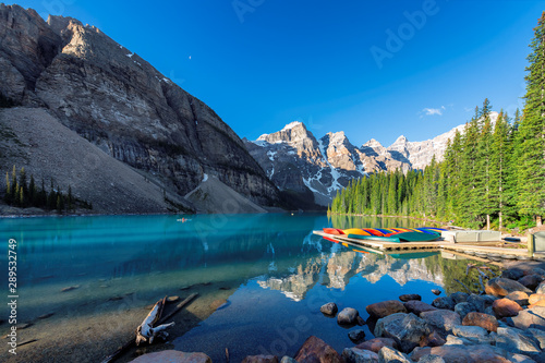 Beautiful sunrise under turquoise waters of the Moraine lake in Canadian Rockies, Banff National Park, Canada
