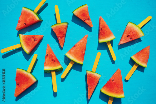 Fresh watermelon slices on the blue background. Summer fruit concept.