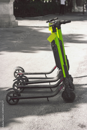 Electic scooters parked on the street, with copy space