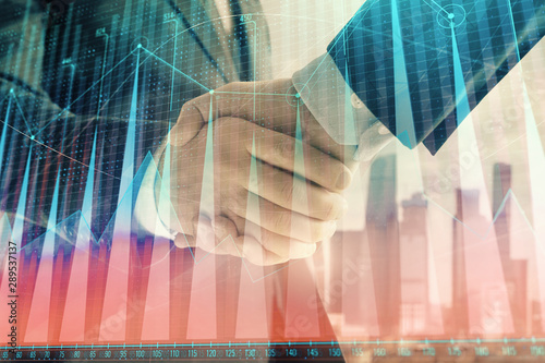 Wallpaper Mural Double exposure of financial graph on cityscape background with two businessman handshake. Concept of stock market deal Torontodigital.ca
