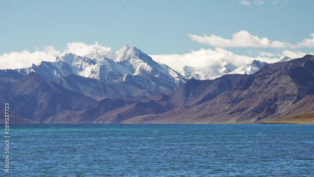 Picturesque landscape of idyllic Tso Moriri lake and Gya Mount snow peak at an altitude of 6795. Bauty of high Himalayan mountain range under blue cloudy sky, Ladakh, India. Peaceful asian wild nature Picturesque landscape of idyllic Tso Moriri lake and Gya Mount snow peak at an altitude of 6795. Bauty of high Himalayan mountain range under blue cloudy sky, Ladakh, India. Peaceful asian wild nature