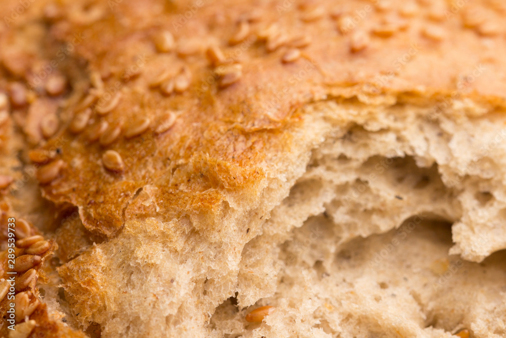 Bun with sesame seeds. Close up . Texture of brown bread with sesame. Bun with sesame seeds. Close up . Texture of brown bread with sesame.