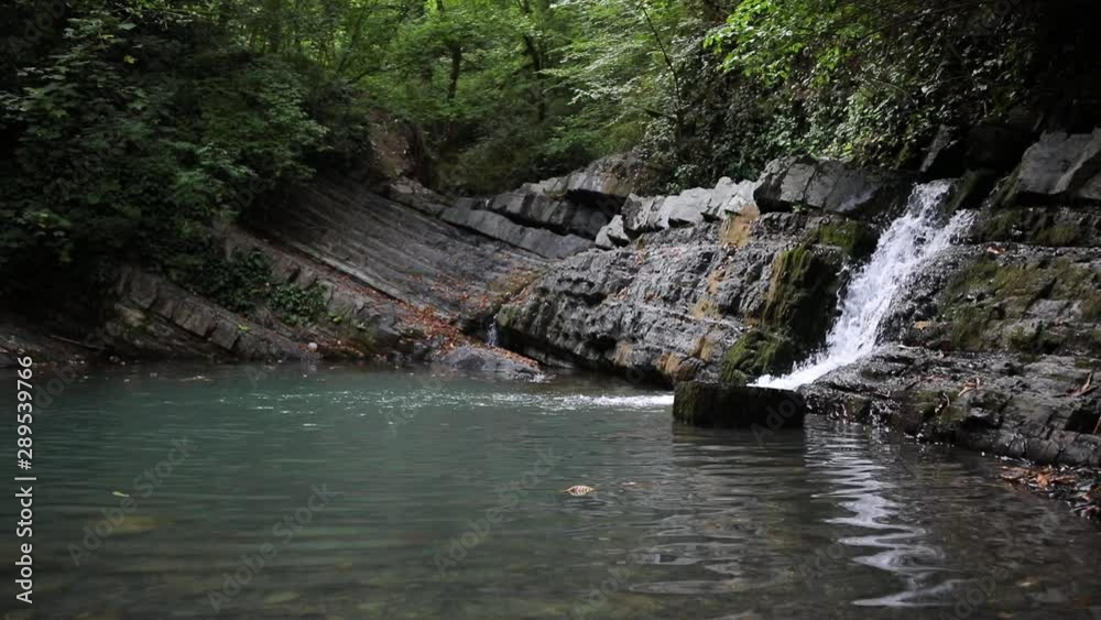 Waterfalls. Several levels of waterfalls. Video with waterfalls. video of flowing water, flowing stream among stones. Stream in the forest Waterfalls. Several levels of waterfalls. Video with waterfalls. video of flowing water, flowing stream among stones. Stream in the forest
