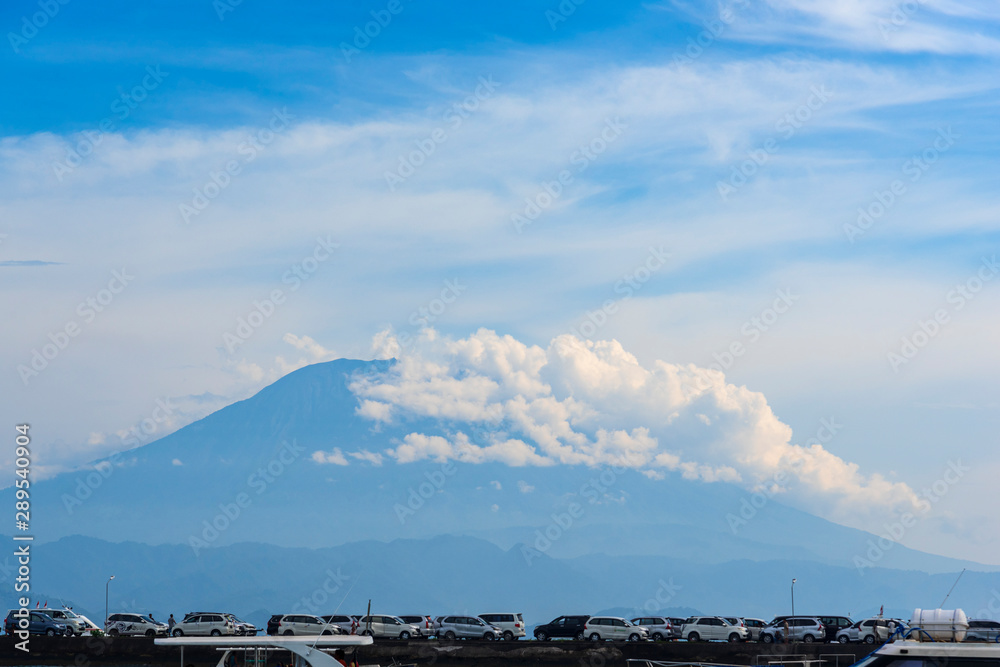 volcano Agung mountains of Bali view from nusa penida and sea and beach with car piar's penida island at in morning background volcano Agung mountains of Bali view from nusa penida and sea and beach with car piar's penida island at in morning background