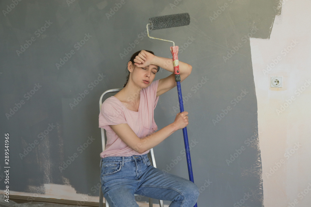 Portrait of a young woman taking a break in the middle of a DIY home improvement project Portrait of a young woman taking a break in the middle of a DIY home improvement project