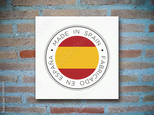 Made in Spain flag icon on a brick background. photo