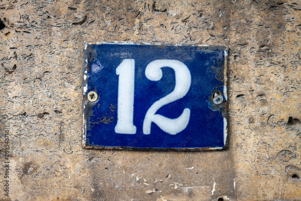 Number 12, twelve, street number sign on the wall Number 12, twelve, street number sign on the wall