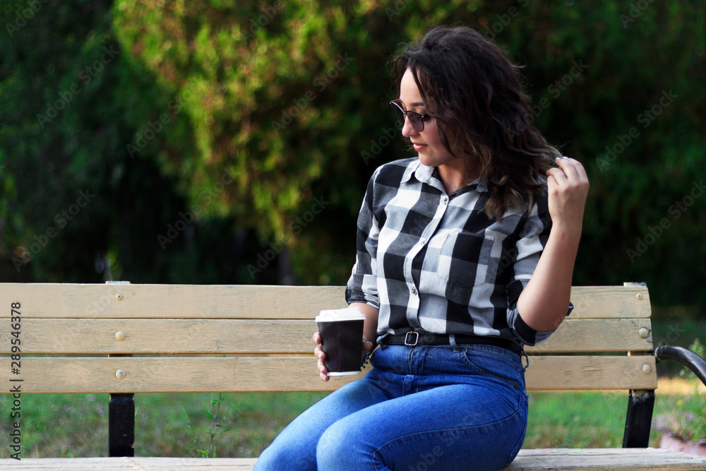 Obraz premium girl with coffee on the bench 