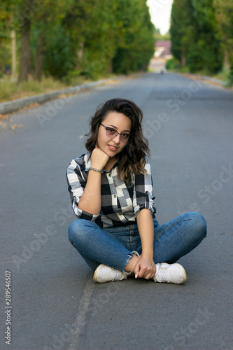 girl sitting on the pavement	