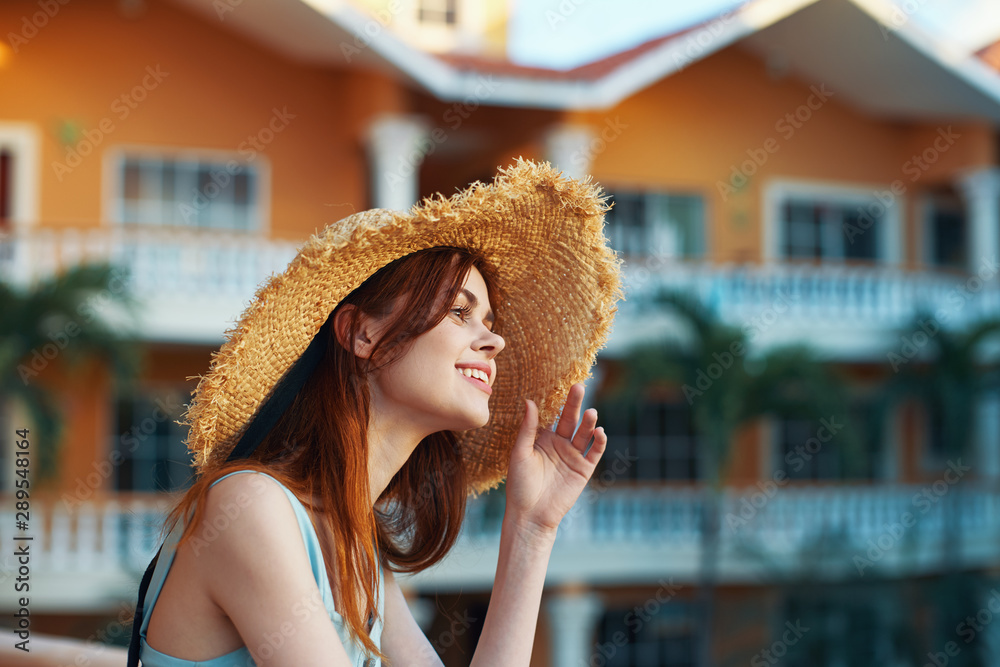 Cheerful woman in a beach hat