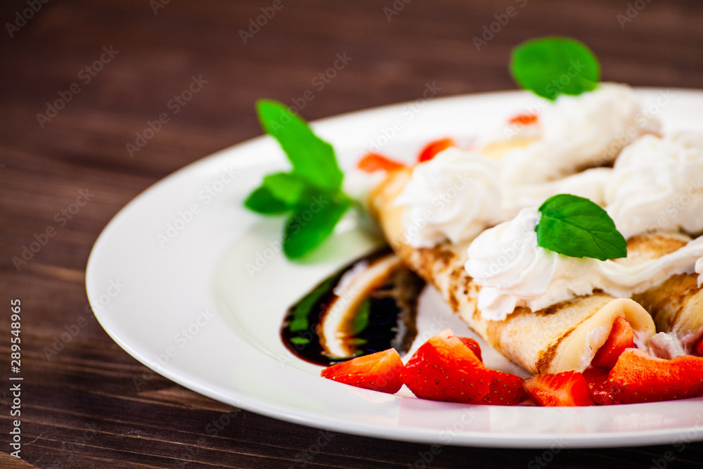 Crepes with cream and strawberries Crepes with cream and strawberries