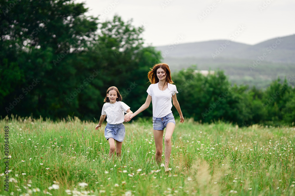 happy mother and daughter in the park happy mother and daughter in the park