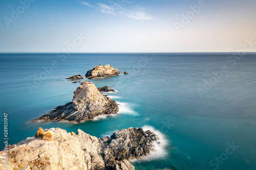 Beautiful long exposure coastal landscape with some isolated rocks taken at Sunset, located at Almuñecar, Granada, Spain