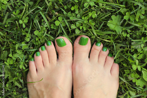 Green pedicure for women's short nails.Nail design in nature colors. photo