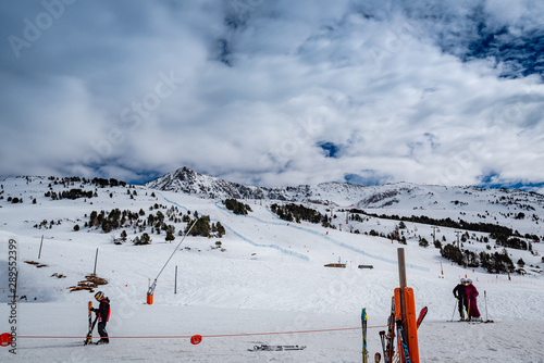Ski pistes with skiers over spanish mountains slopes at Baqueira Beret ski resort
