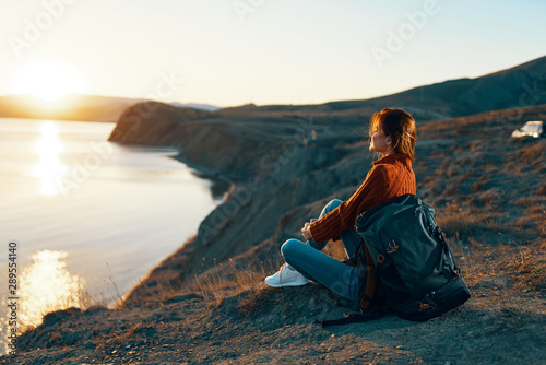 woman sitting on rock