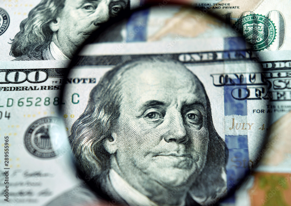 Dollar banknote through magnifying lens (corruption, lobbying, inflation, financial secrecy - concept). Vintage effect.