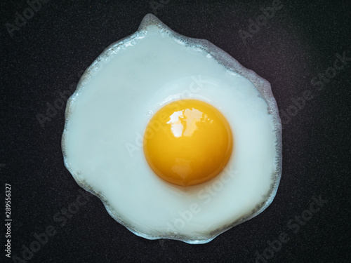 Fried egg. Close up view of the fried egg on a frying pan