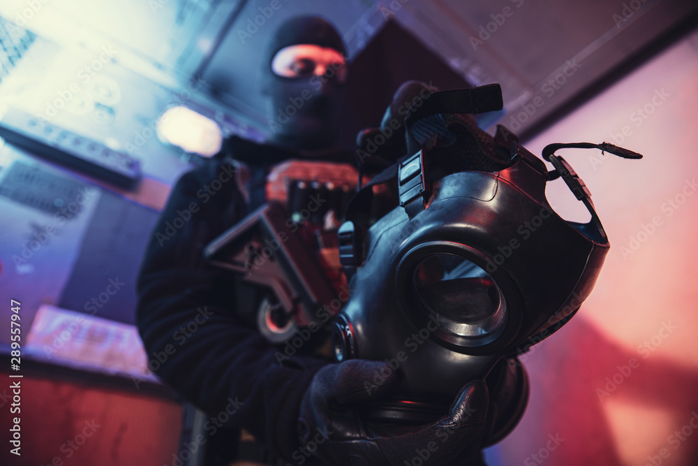 Gas mask in hand of special unit soldier Gas mask in hand of special unit soldier