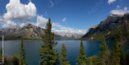 Beautiful Panoramic View of Canadian Mountain Landscape during a vibrant sunny summerday. Taken in Lake Minnewanka, Banff National Park, Alberta, Canada.