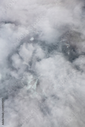 Aerial View from Above of a beautiful rocky beach covered in Clouds and Fog at the West Pacific Ocean Coast. Taken near Tofino and Ucluelet in Vancouver Island, BC, Canada.