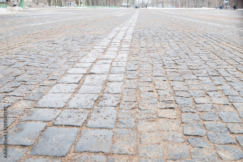 Cobblestone pavement.Vintage stone street road pavement texture.pattern of stone block paving.Selective focus.Granite cobble stoned pavement background. old cobblestone pavement