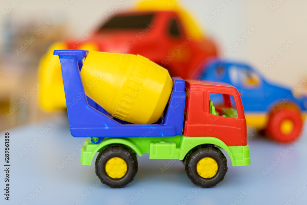 toy cars on the table.Children's playroom with plastic colorful educational blocks toys. Games floor for preschoolers kindergarten. interior children's room. Free space. toy cars on the table.Children's playroom with plastic colorful educational blocks toys. Games floor for preschoolers kindergarten. interior children's room. Free space.