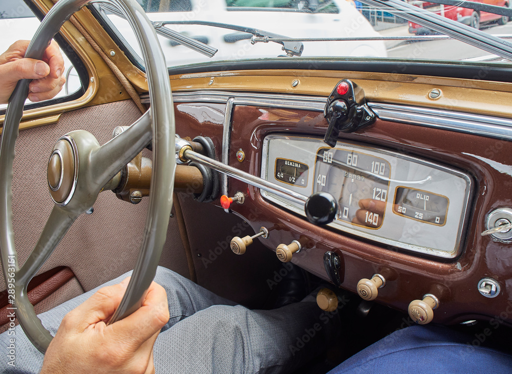 Obraz premium A male hands driving an Italian classic car.