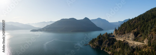 Aerial panoramic view of the Sea to Sky Highway in Howe Sound  North of Vancouver  British Columbia  Canada. Taken during a sunny summer day.