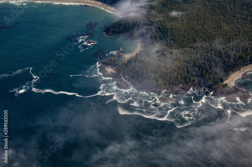 Aerial View from Above of a beautiful beach covered in Clouds and Fog at the West Pacific Ocean Coast. Taken near Tofino and Ucluelet in Vancouver Island, BC, Canada.