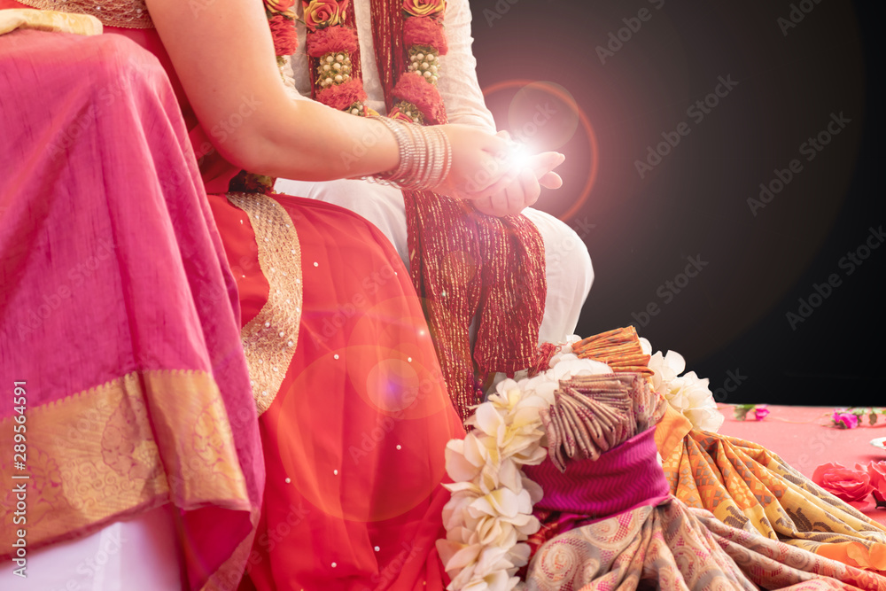 Indian wedding ceremony, bride and groom holding fire in hands on black  background with copy space Stock Photo | Adobe Stock