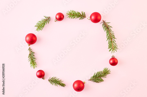 Flat lay christmas frame with spruce branches and christmas decorations on a color background