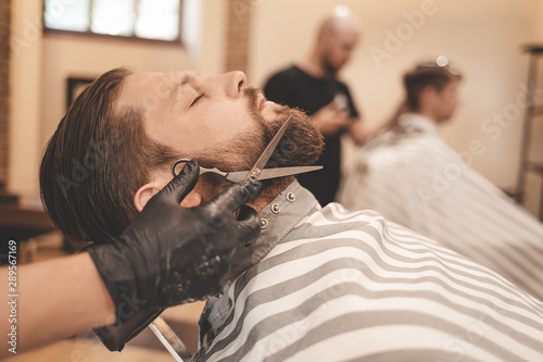  side view of a beard cut and styling in a barbershop